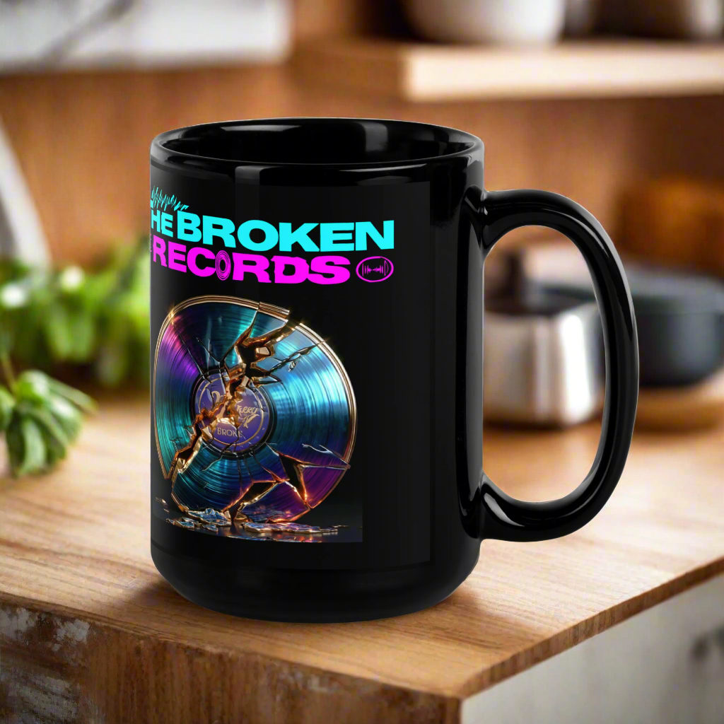Black mug with 'The Broken Records' design on a wooden surface